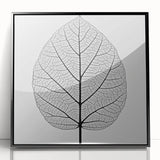 Large abstract wall art featuring close-up leaves in green and black, acrylic print in black frame.