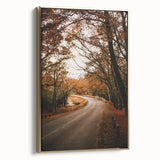 Framed canvas featuring a vintage-style landscape painting of an autumnal scene with muted gold and black tones.