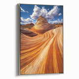 Framed canvas artwork depicting a serene desert landscape in warm hues of orange and gold, showcased with a sleek silver frame, ideal for modern home decor.
