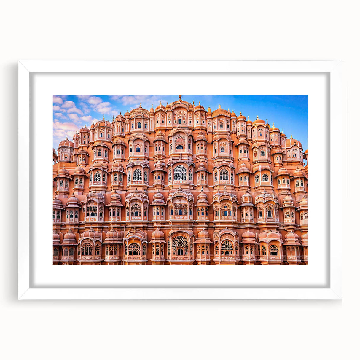 Abstract art print of an Indian scenery in muted earth tones on a white framed canvas.
