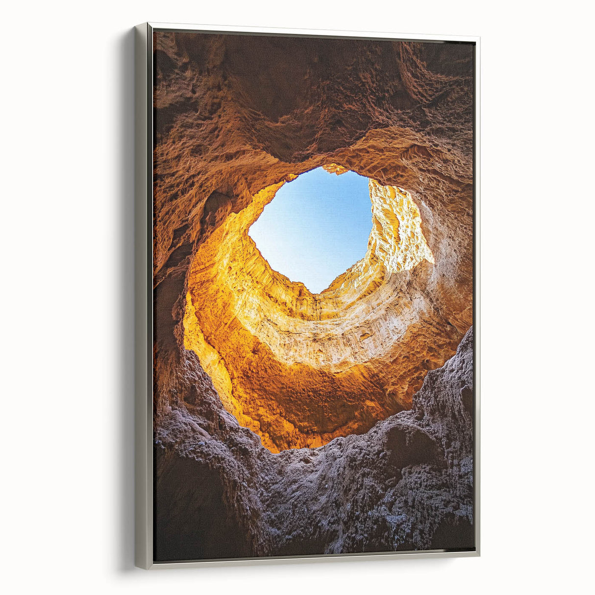 Framed canvas artwork showcasing a stunning landscape of caves, with a sleek silver frame accentuating the design, ideal for modern home decor.