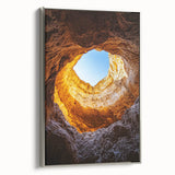 Framed canvas artwork showcasing a stunning landscape of caves, with a sleek silver frame accentuating the design, ideal for modern home decor.