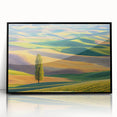 Framed acrylic artwork showcasing a vibrant landscape of rolling fields under a blue sky, with a sleek black frame, perfect for modern home decor.
