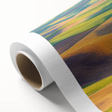 Rolled canvas showcasing a vibrant landscape design with fields and rolling hills, featuring rich greens and warm earth tones, elegantly packaged in a protective tube.