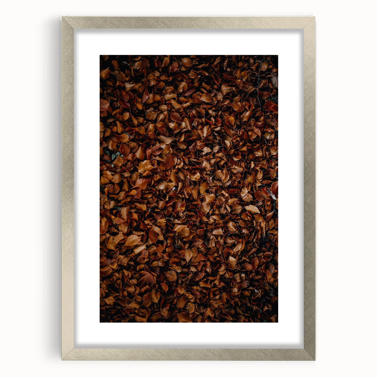 Textured art depicting abstract fall scenery in muted orange and brown tones on a framed silver mat.