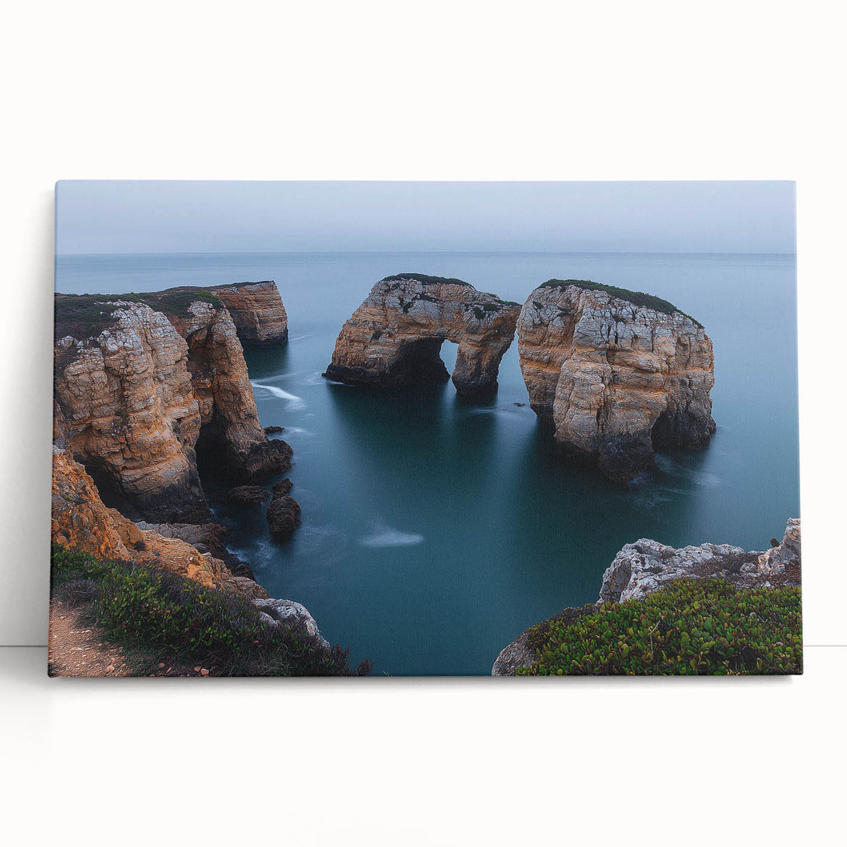 Stretched canvas artwork depicting a dramatic landscape of rugged cliffs under a vibrant sunset sky, perfect for modern home decor and art enthusiasts.
