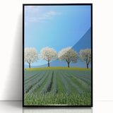 Framed acrylic artwork showcasing a vibrant landscape with rolling green fields and a clear blue sky, presented in a sleek black frame, ideal for modern home decor.