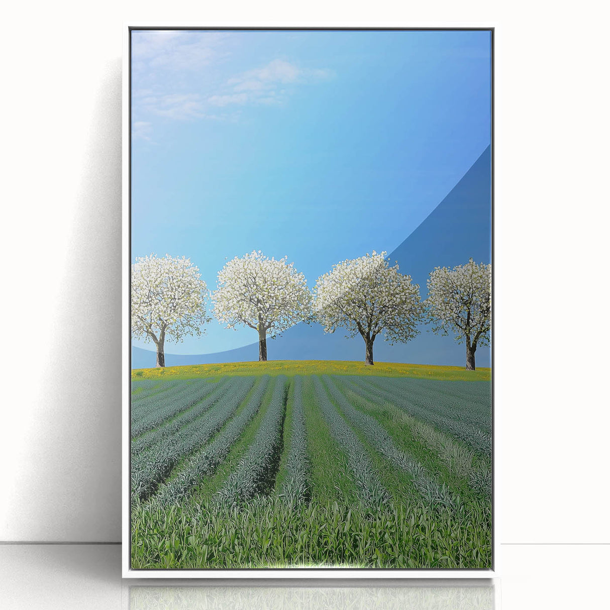 Framed acrylic artwork showcasing a vibrant landscape of rolling fields under a blue sky, set in a sleek white frame for modern home decor. Ideal for enhancing living spaces with nature-inspired aesthetics.