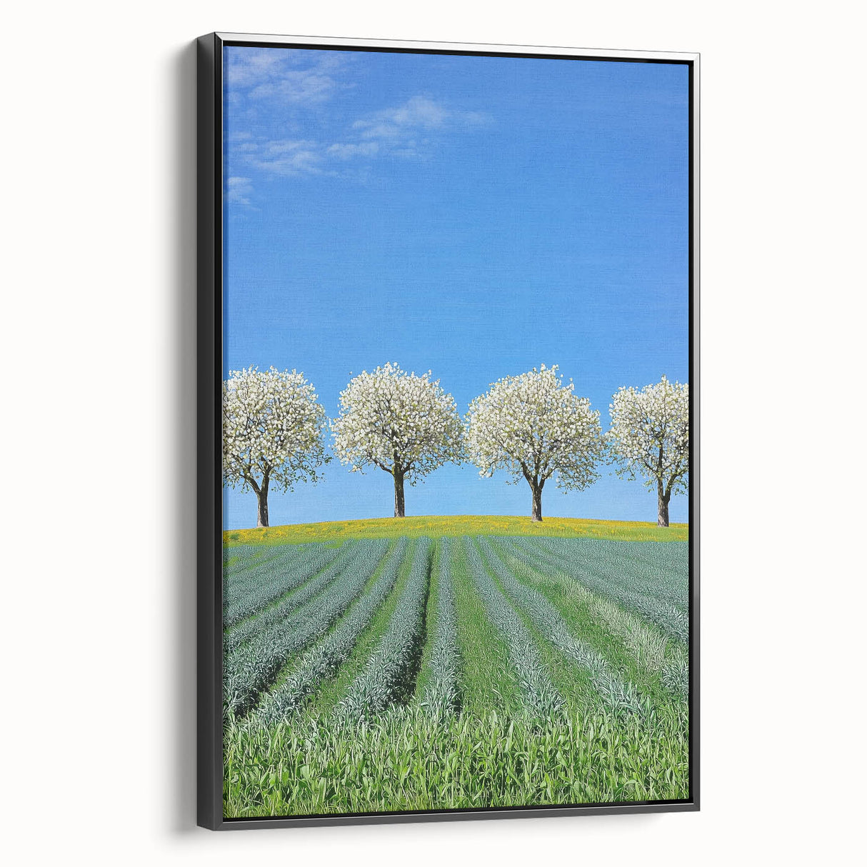 Framed canvas artwork depicting serene green landscapes and golden fields, showcasing a black frame and side view for an elegant home decor accent. Ideal for nature lovers seeking vibrant wall art to enhance their living space.