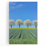 Vibrant stretched canvas artwork depicting a serene landscape of rolling green fields under a bright blue sky, perfect for enhancing home decor.