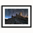 Black-framed landscape artwork showcasing a majestic castle surrounded by lush greenery and a serene sky, elegantly matted for a sophisticated display.