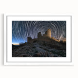 Framed landscape artwork depicting a majestic castle surrounded by lush greenery, featuring a white mat and elegant frame, perfect for home decor.