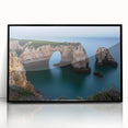 Framed acrylic artwork showcasing a stunning landscape of dramatic cliffs under a vibrant blue sky, designed to enhance modern decor with its sleek black frame.