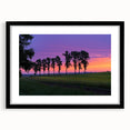 Black-framed landscape artwork showcasing a serene countryside scene with vibrant greenery and a clear blue sky, elegantly matted for a polished look.