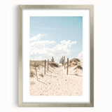 Abstract textured art print in warm orange and yellow tones, framed in silver, ideal for bedroom wall decor.