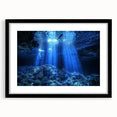 Black-framed landscape print displaying intricate cave formations, showcasing earthy tones and textures, perfect for enhancing modern interior decor.
