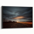 Framed canvas artwork depicting a serene countryside landscape with lush green fields, vibrant blue sky, and rustic charm, presented in a sleek black frame for modern decor.