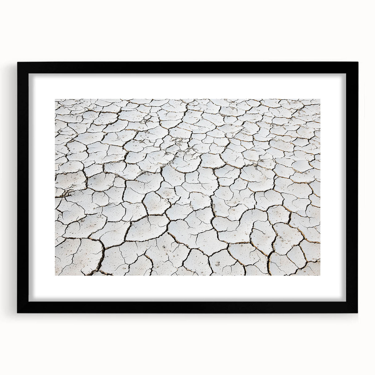 Black-framed landscape artwork depicting a serene desert scene, featuring warm earth tones and intricate details, ideal for home decor or office aesthetics.