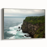 Framed canvas artwork depicting a stunning landscape with dramatic cliffs and vibrant colors, featuring a sleek silver frame that enhances its modern aesthetic.
