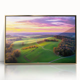Framed acrylic artwork showcasing a serene countryside landscape with lush green fields and golden hues, elegantly displayed in a stylish gold frame. Perfect for enhancing home decor.