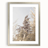 Textured abstract art print in warm yellow and orange tones on a silver-framed canvas, ideal for bedroom art.