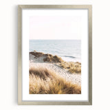 Textured abstract art print in vibrant orange and red hues, framed in silver, ideal for bedroom decor.