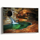 Framed canvas artwork showcasing a stunning landscape scene with intricate cave formations, set in a sleek silver frame, perfect for modern home decor.