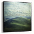 Framed black canvas showcasing a tranquil countryside landscape with rolling hills and a vibrant sunset, enhancing any room's decor with nature's beauty.