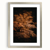Textured abstract art print of autumn leaves in earthy tones on a framed silver mat, suitable for bedroom decor.
