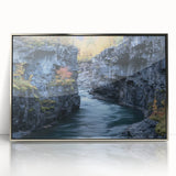 Framed acrylic landscape artwork showcasing vibrant canyons in rich earthy tones, elegantly displayed in a sleek silver frame, perfect for contemporary home decor.