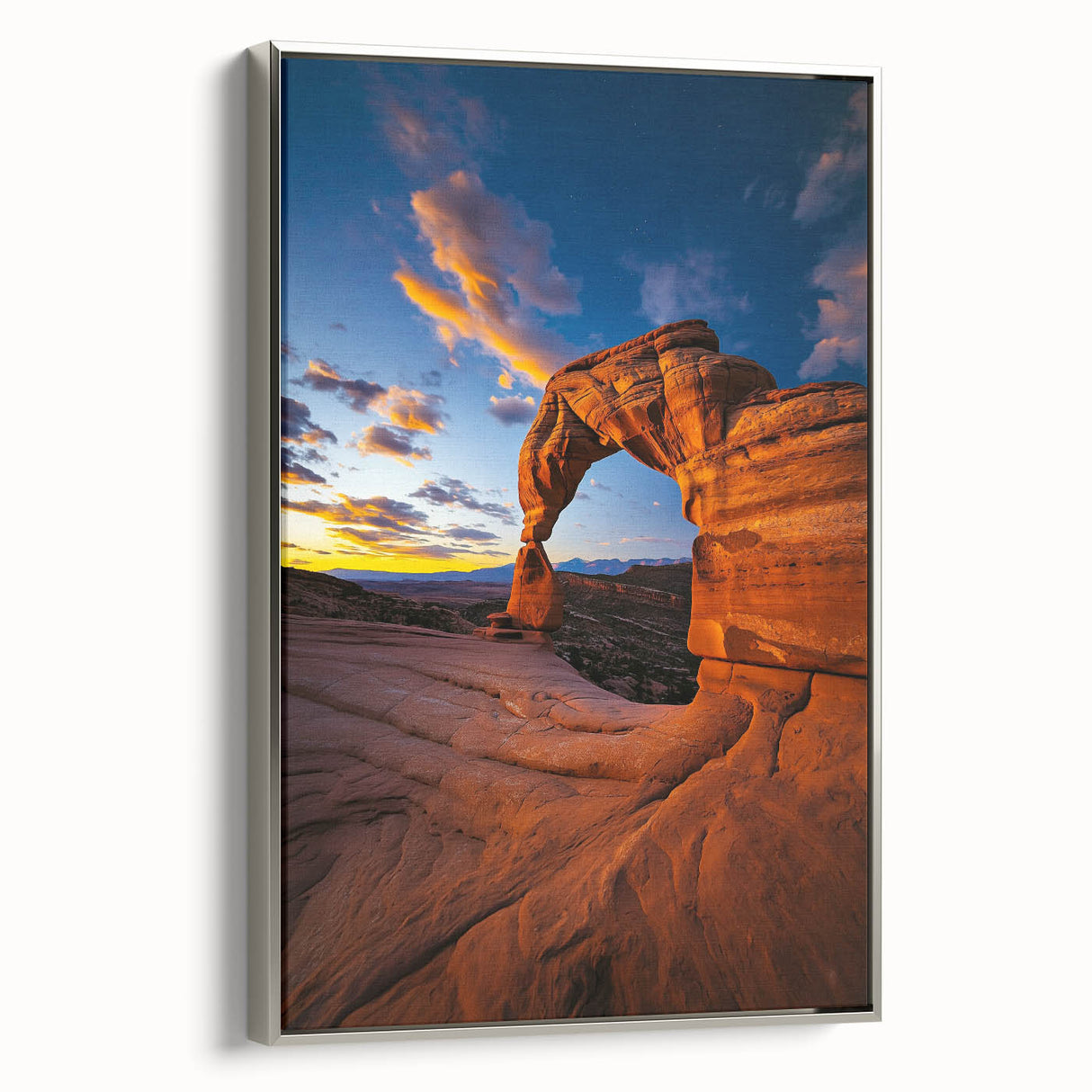 Framed canvas artwork depicting a serene desert landscape with warm earthy tones and a silver frame, perfect for enhancing home decor and creating a calming atmosphere.