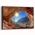Framed canvas artwork depicting a stunning desert landscape, showcasing warm tones of orange and brown with a black frame, perfect for home decor.