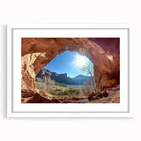 Desert landscape artwork framed in a sleek white mat, showcasing warm tones of orange and brown. Ideal for home decor, this piece adds a serene touch to any space.