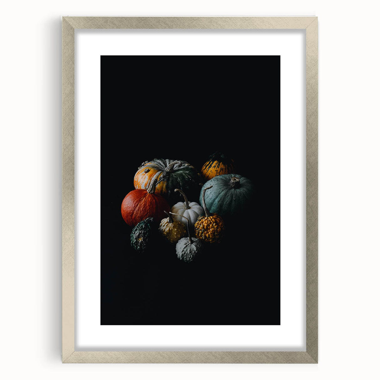 Textured art of abstract autumn leaves in orange and red, framed in silver, ideal for bedroom wall decor.