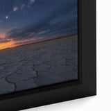 Close-up of a framed canvas artwork depicting a serene desert landscape, showcasing warm tones of orange and yellow with intricate textures, ideal for modern home decor.