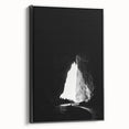 Framed canvas art depicting a serene landscape with caves, showcased in a sleek black frame, perfect for enhancing modern home decor.
