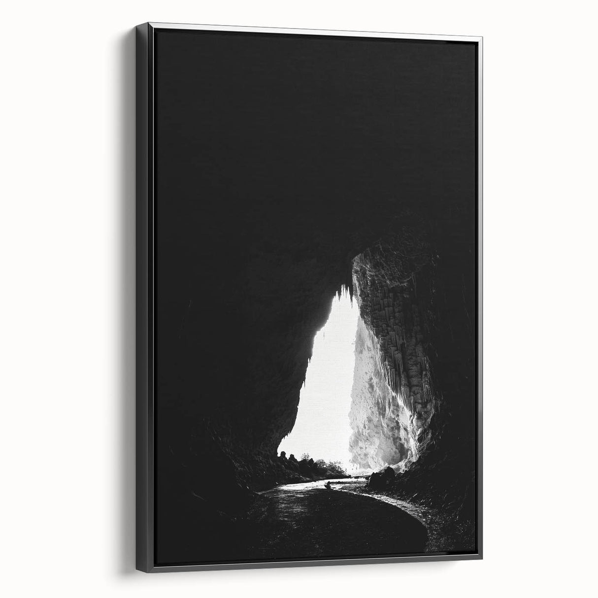 Framed canvas art depicting a serene landscape with caves, showcased in a sleek black frame, perfect for enhancing modern home decor.