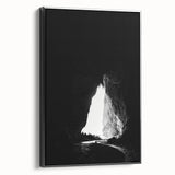 Framed canvas art depicting a serene landscape with caves, showcased in a sleek black frame, perfect for enhancing modern home decor.