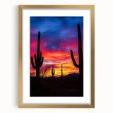 Desert landscape art print framed in gold with a white mat, showcasing warm earth tones and intricate details, perfect for modern home decor aesthetics.