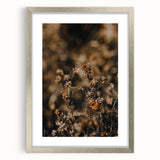 Textured abstract art print in orange and red tones on a silver-framed canvas, suitable for bedroom decor.