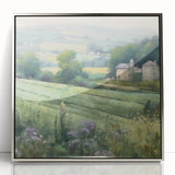 Framed acrylic wall art depicting a serene countryside landscape, showcasing vibrant greens and soft blues, with a sleek silver frame enhancing modern decor.