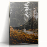 Mid-century modernist art depicting an abstract fall scene in warm orange and brown tones on a silver-framed acrylic print.