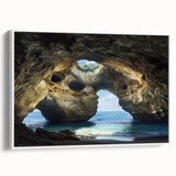 Framed canvas artwork showcasing a serene landscape with caves, presented in a white frame, ideal for enhancing modern home decor. Perfect for art lovers seeking unique wall accents.