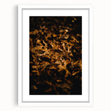 Abstract art print of autumn leaves in orange and red tones on a white framed canvas, ideal for dining room decor.