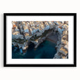 Framed black landscape artwork depicting dramatic cliffs with a mat, showcasing intricate details and textures, perfect for modern home decor.
