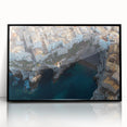 Framed acrylic artwork showcasing a dramatic landscape of rugged cliffs in vibrant colors, set against a sleek black frame, ideal for modern home decor.