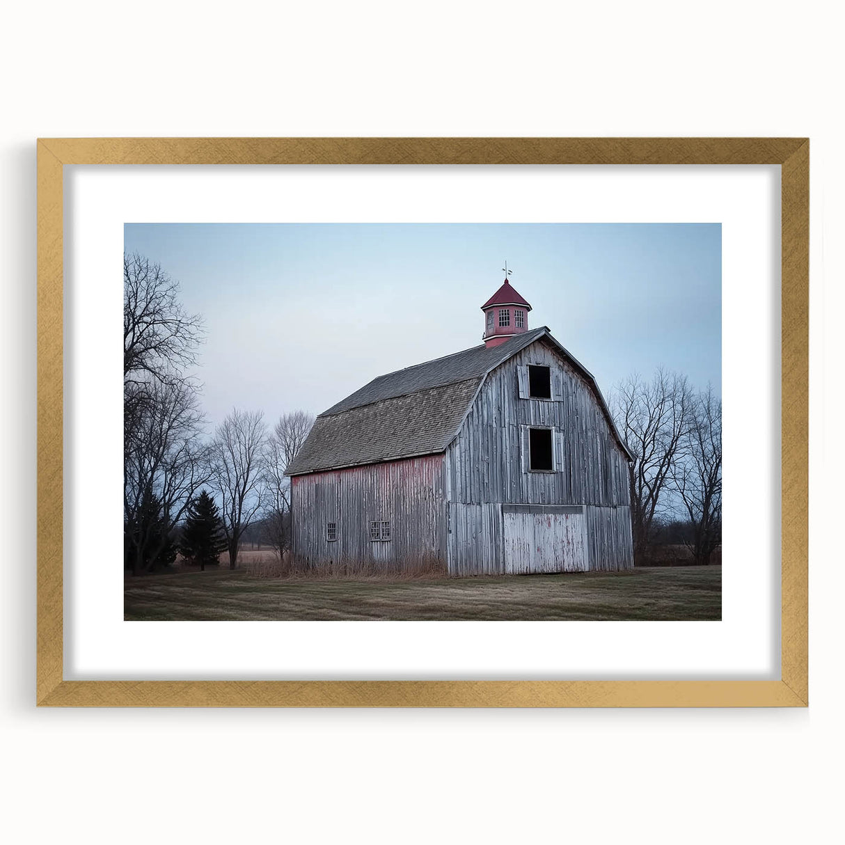 Landscape barn frame with a gold mat showcasing a rustic design, positioned against a neutral background to highlight its elegant craftsmanship and charm.