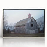 Framed acrylic artwork showcasing a serene landscape featuring a rustic barn, set against a vibrant sky. The silver frame enhances its modern appeal, perfect for home decor.