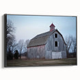 Landscape barn-themed canvas print displayed in a black frame, showcasing rustic natural tones and a textured finish, perfect for farmhouse decor.