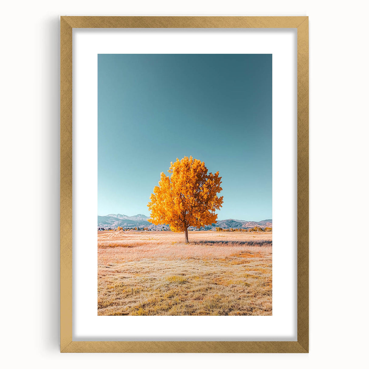 Elegant gold-framed landscape artwork showcasing vibrant fields under a clear blue sky, featuring a classic mat for added dimension and style. Perfect for home decor.
